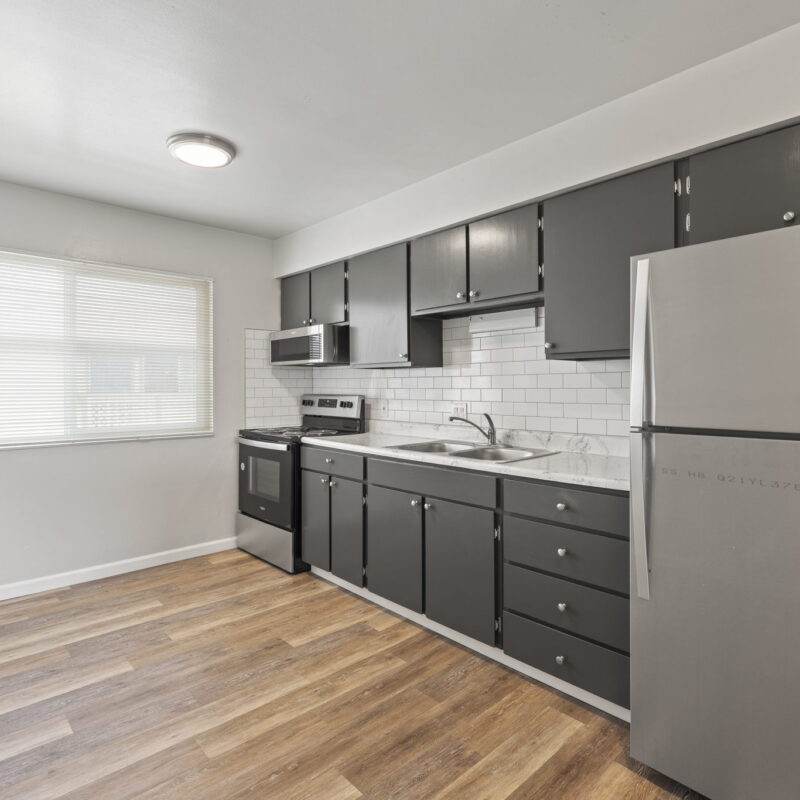 Modern kitchen with stainless steel appliances and wood floor