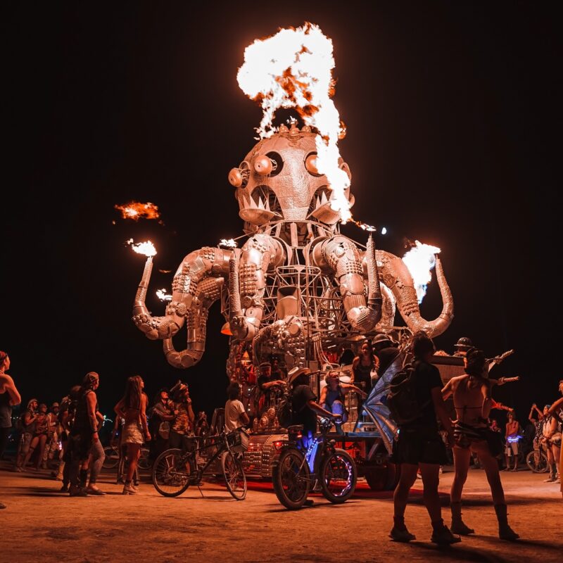 Fire-breathing octopus art installation at nighttime festival