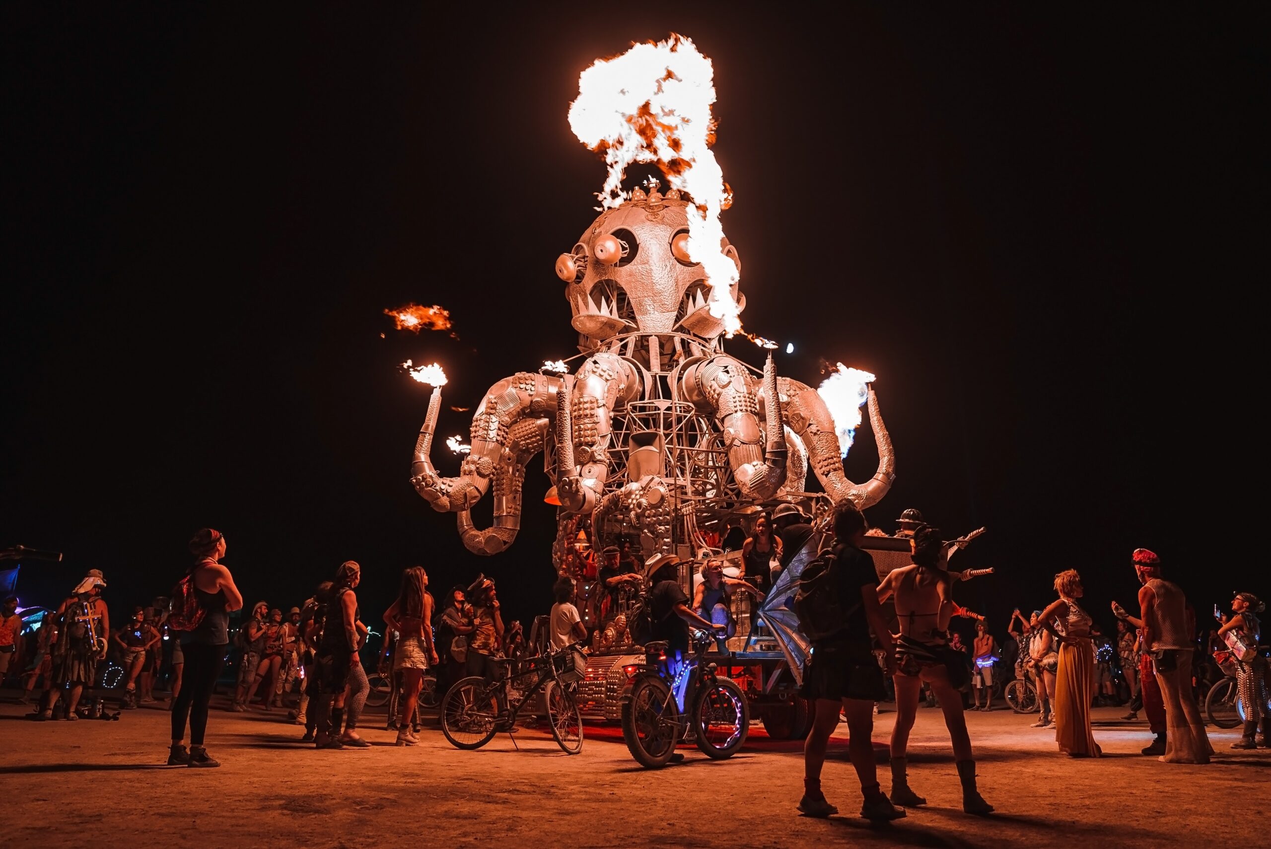 Fire-breathing octopus art installation at nighttime festival